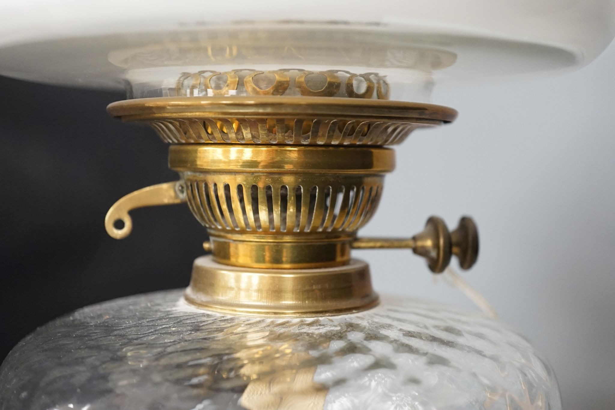 A brass oil lamp with opaque shade 60cm total height